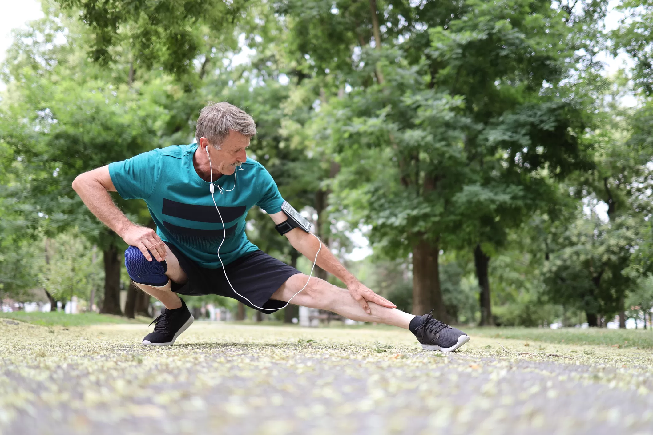 Man with headphones stretching