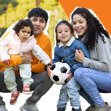 family of four playing soccer