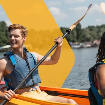 two friends paddling in a canoe